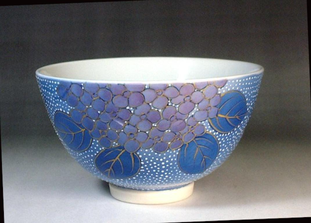 Exquisite contemporary Japanese decorative porcelain match tea cup, extremely intricately hand painted in various shades of blue and pink set against a stunningly shaped ovoid porcelain body in blue, to create a mesmerizing surface. It is lavishly