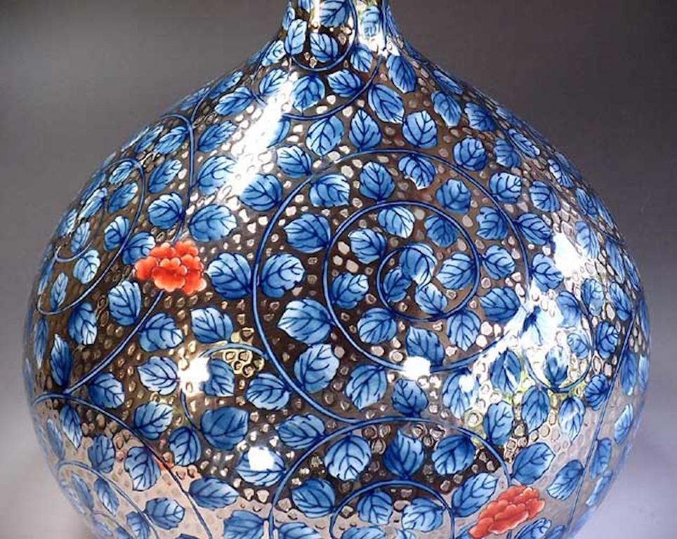 Exquisite contemporary dimpled decorative porcelain vase in blue on platinum, a stunning piece hand painted by a highly acclaimed porcelain artist of Japan’s Imari-Arita region. The artist is the recipient of numerous awards for his exceptional