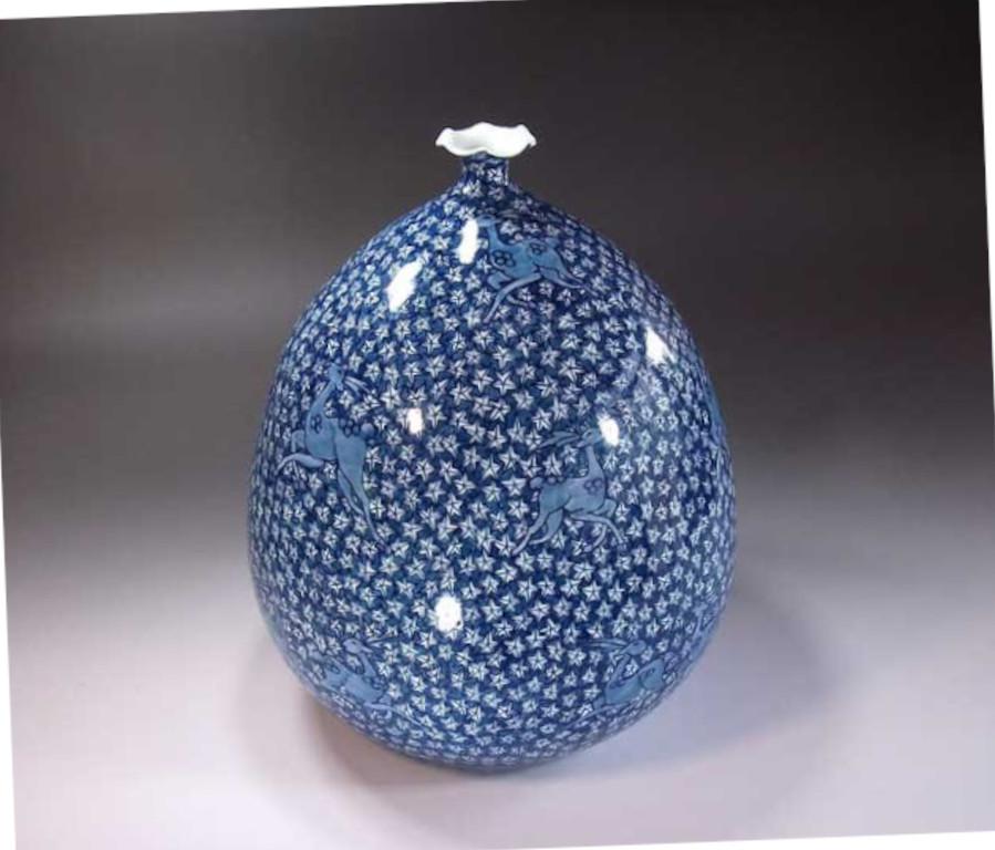 Contemporary Japanese decorative porcelain vase, intricately hand painted in blue on a stunningly shaped porcelain body, by widely acclaimed master porcelain artist in traditional patterns of the Imari-Arita region of Japan and the recipient of