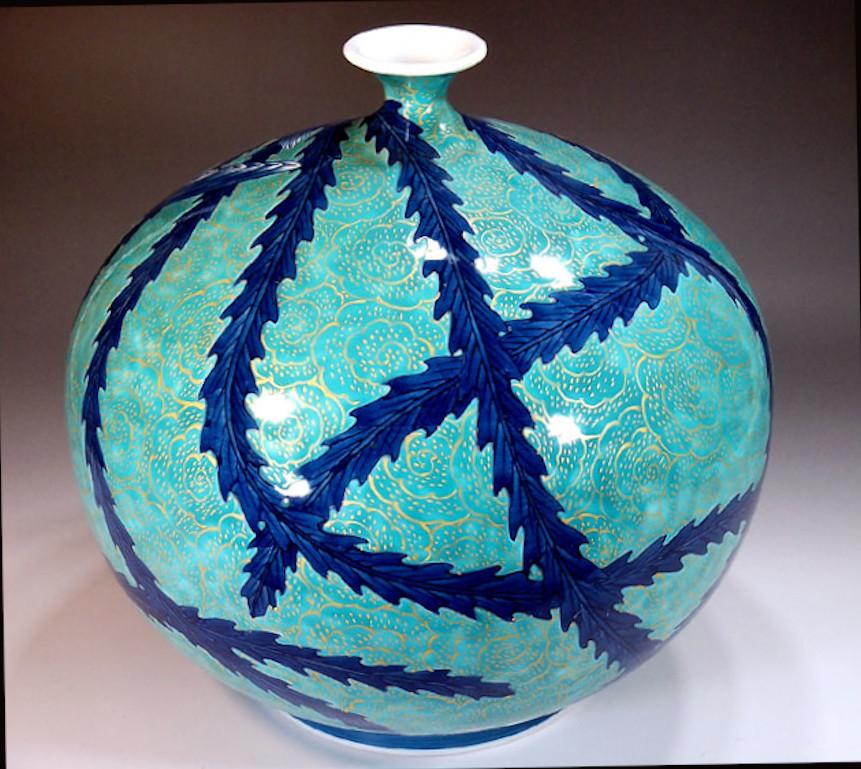 Exquisite contemporary Japanese decorative porcelain vase, hand painted in blue an turquoise on the finest porcelain in a beautiful round shape, the signed work by highly acclaimed award-winning master porcelain artist in the Imari-Arita style. He