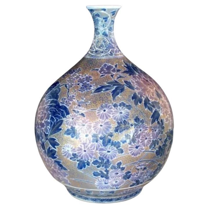 Extraordinary Japanese contemporary museum quality decorative porcelain vase, extremely intricately hand painted on an elegantly shaped porcelain body in blue and purple with extremely intricate patterns and extensive use of high purity gold,