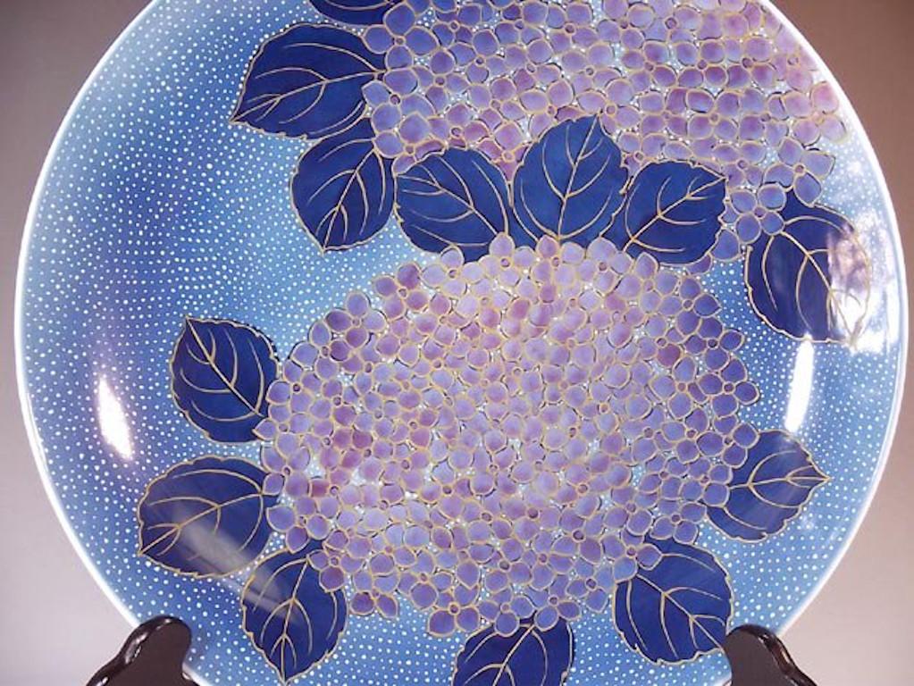 Exquisite contemporary Japanese decorative porcelain charger, extremely intricately hand painted in various shades of blue and purple. It is lavishly decorated with intricate gold details and is a masterpiece by highly acclaimed award-inning master