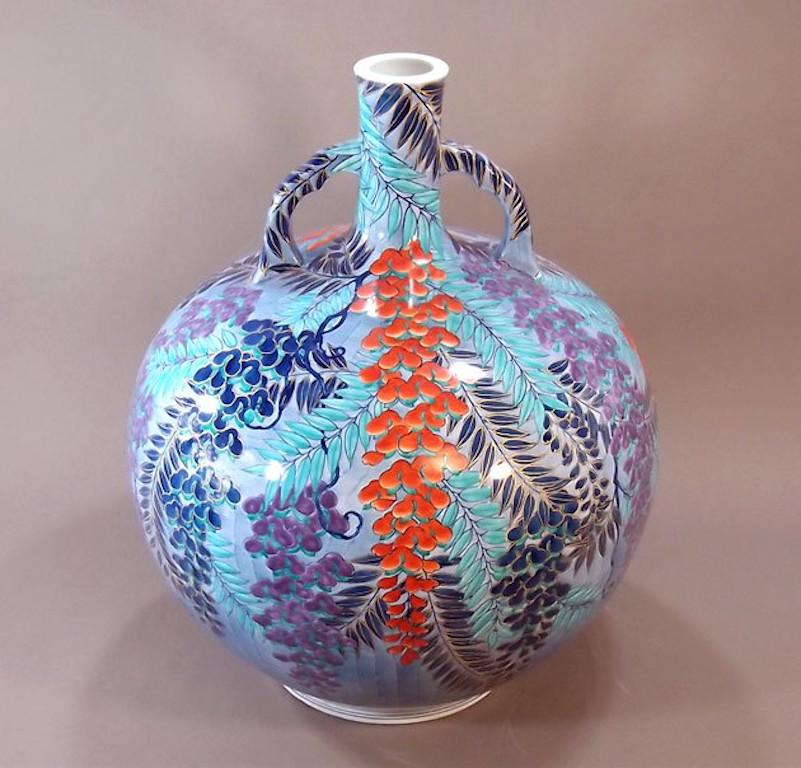 Elegant large Japanese contemporary decorative porcelain vase, intricately hand painted in dark blue, red, purple and turquoise on a beautifully shaped ovoid body with an elegant long neck and two handles, a signed work by highly acclaimed porcelain