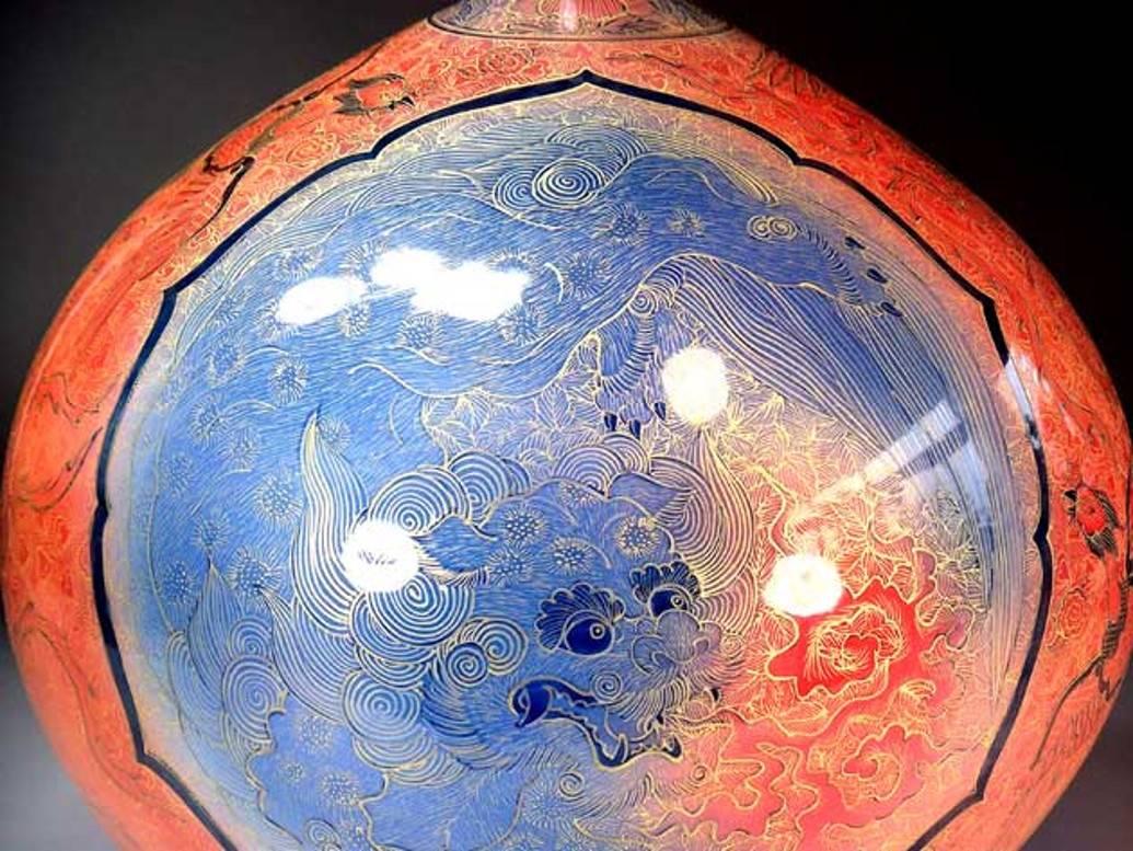 Extraordinary contemporary Porcelain vase in brilliant red, extremely intricately hand painted blue and gold featuring the auspicious “shishi lion and phoenix” motif, a signed masterpiece from the exclusive signature collection by highly acclaimed