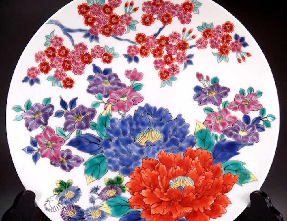 Exquisite Japanese contemporary decorative porcelain charger, hand painted in vivid purple, red and blue, a signed work by highly acclaimed master porcelain artist of Japan’s Imari-Arita region. He is the recipient of numerous awards for his
