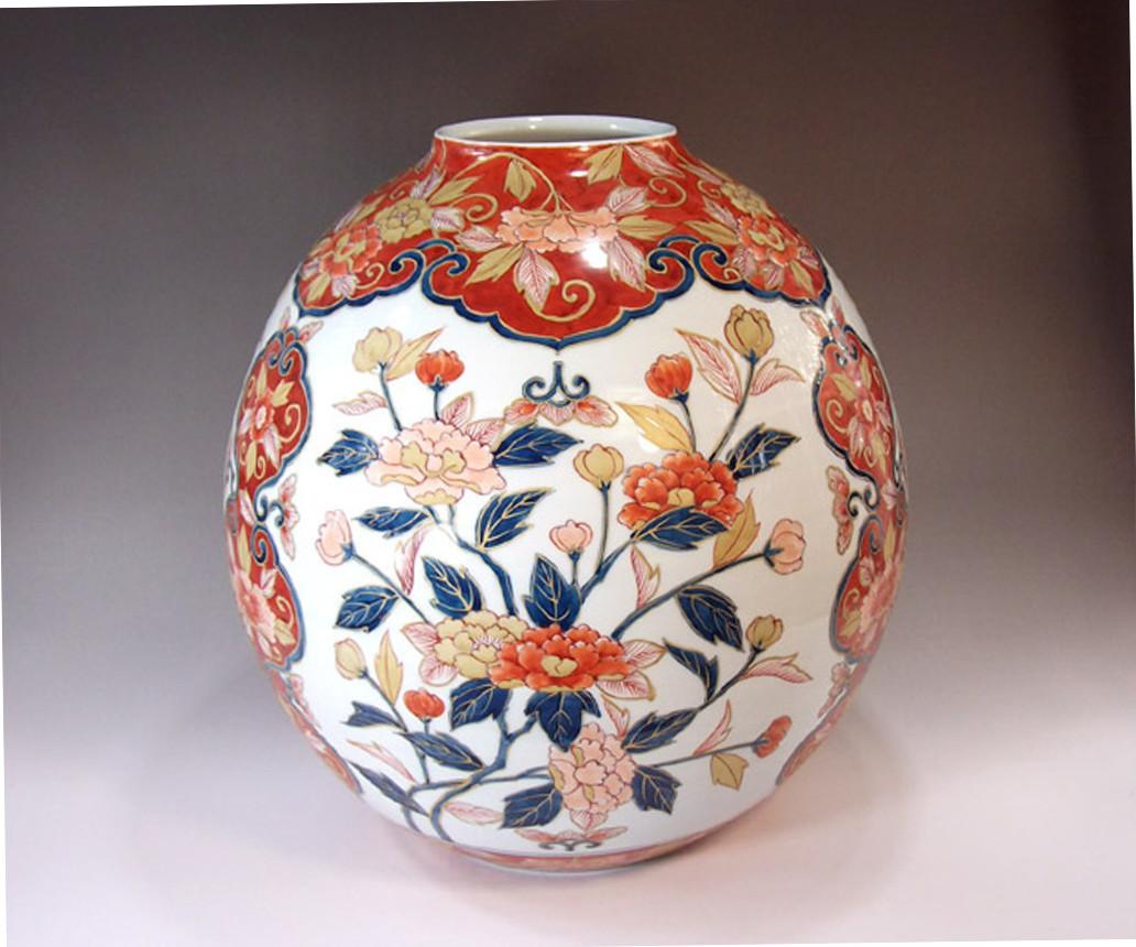 Exceptional Japanese contemporary exquisitely hand-painted decorative porcelain vase in blue, red and white on a stunningly shaped body, a signed masterpiece by highly acclaimed award-winning master porcelain artist of Imari-Arita region of Japan.