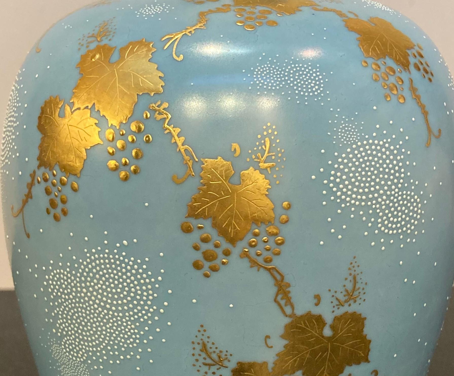 Exquisite Japanese contemporary collectible decorative porcelain vase, a stunning masterpiece by a celebrated award-winning third-generation master porcelain artist of the Kutani region of Japan featuring grape vines rendered in pure gold in chibu