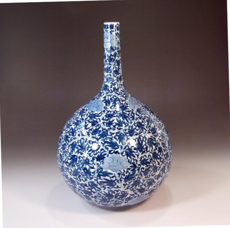 Exquisite Japanese contemporary decorative porcelain vase, intricately hand painted in blue and white on an elegant bottle shape large body, a signed piece by highly acclaimed master porcelain artist of the Imari-Arita region of Japan. This artist