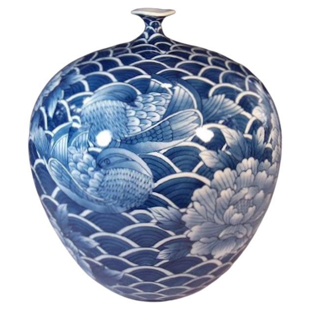 Exceptional Japanese contemporary decorative porcelain vase, intricately hand painted in deep blue on an stunningly shaped body, a signed masterpiece by highly acclaimed master porcelain artist of the Imari-Arita region of Japan. He is the recipient