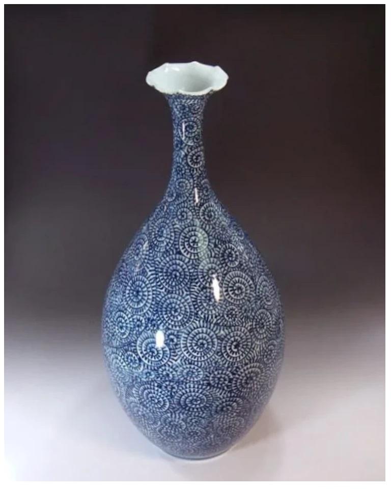 Extraordinary Japanese contemporary decorative porcelain vase, intricately hand painted in a stunning blue underglaze on an elegantly shaped body, a signed piece by highly acclaimed master porcelain artist of the Imari-Arita region of Japan. In