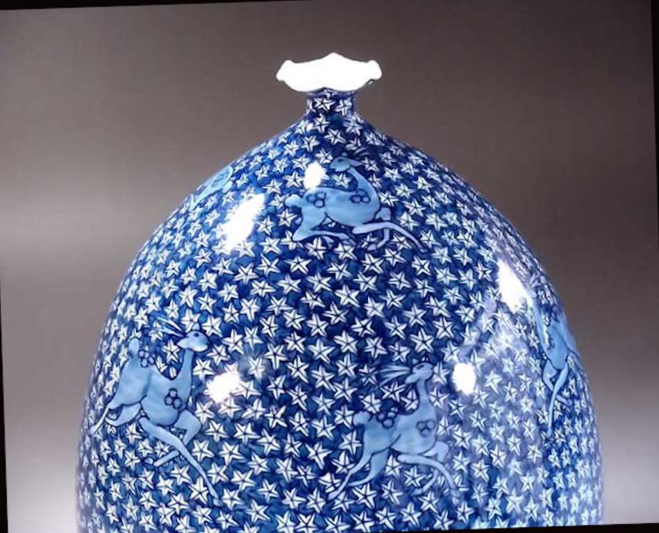Exquisite contemporary Japanese decorative porcelain vase, intricately hand painted in various shades of blue on an elegantly shaped body, a signed piece by master porcelain artist from the Arita-Imari region in Japan. In 2016, the British Museum