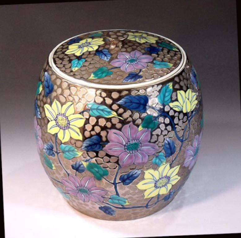 Exquisite contemporary Japanese signed decorative porcelain mizusashi/lidded jar, hand painted in purple, blue and yellow, set against a stunning dimpled body in platinum, by highly acclaimed porcelain artist of Japan’s Imari-Arita region. The