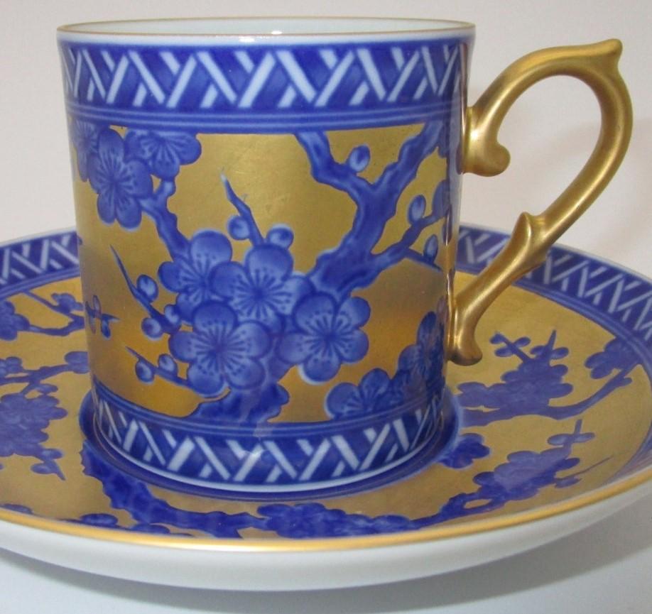 Exquisite contemporary gilded hand painted porcelain cup and saucer in cobalt blue. This extraordinary piece brings showcases the glory of Imari style combined with a modern touch, with its generous application of gold and underglazed pine tree in