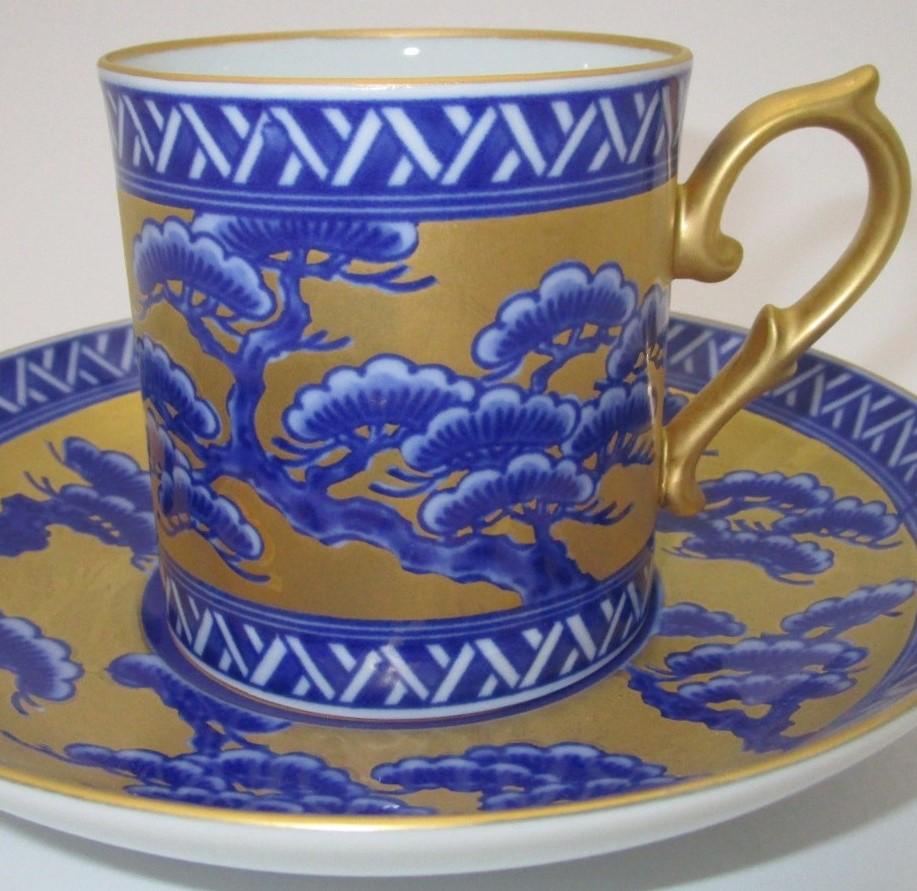 Unique Japanese contemporary gilded hand painted porcelain cup and saucer. This extraordinary piece showcases the glory of Imari style combined with a modern touch, with its generous application of gold and underglazed pine tree in beautiful shades