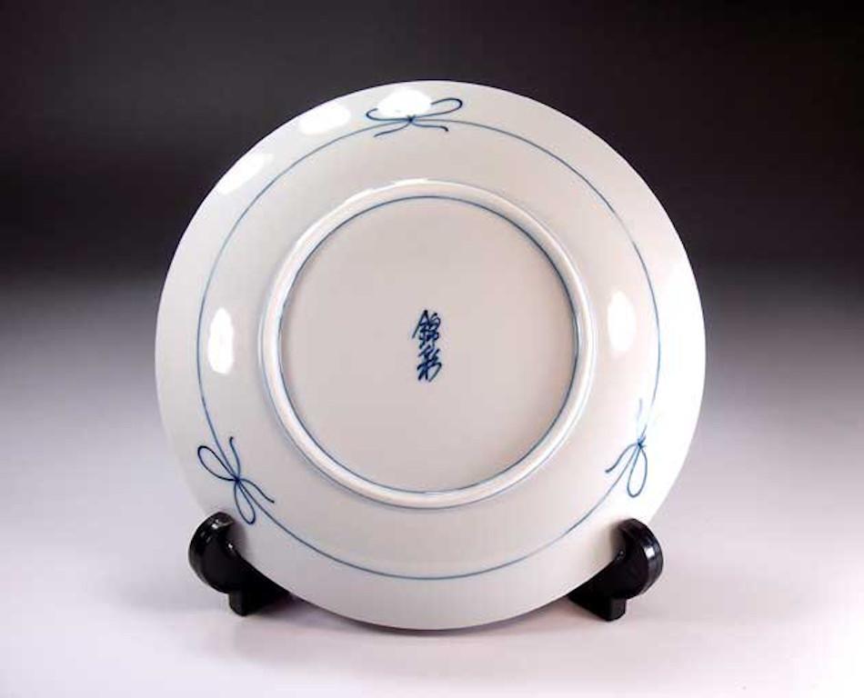 Exquisite Japanese contemporary Japanese decorative porcelain charger, hand painted in platinum and gold, set against a dimpled black background, a signed piece belonging to the signature fish collection by highly acclaimed master porcelain artist.
