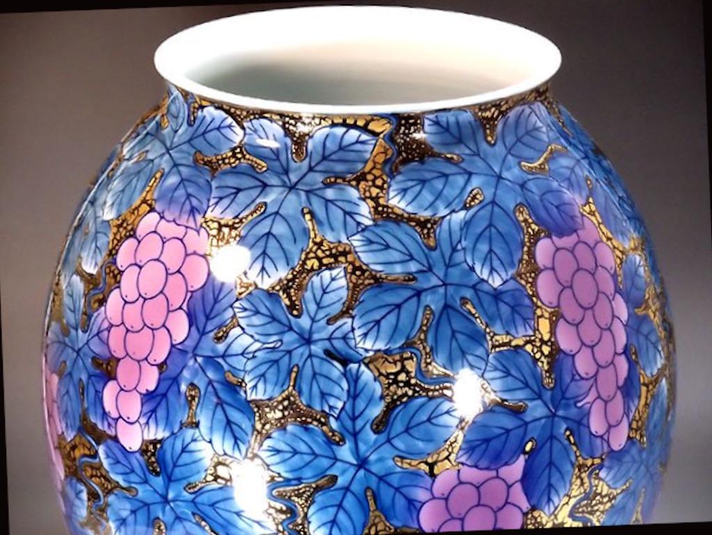 Unique Contemporary Japanese decorative porcelain vase, intricately hand painted in blue and pink on a beautifully shaped body, set against a stunning background of intricate tenmoku pattern on black to create a transparent surface, a signed