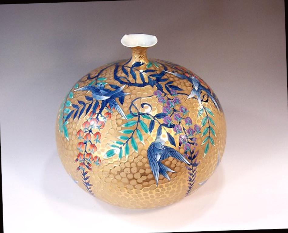 Japanese contemporary dimpled decorative porcelain vase, a stunning signed piece gilded and hand painted by highly acclaimed porcelain artist of Japan’s Imari-Arita region. The artist is the recipient of numerous awards for his exceptional porcelain