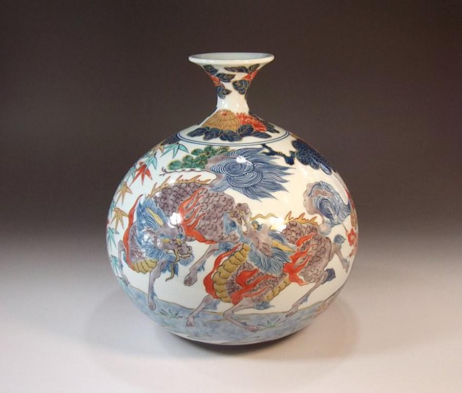 Contemporary Japanese decorative porcelain vase, hand painted in green, blue, red and gold on a beautifully shaped porcelain body, a signed work by highly acclaimed award-winning master porcelain artist of the Imari-Arita region of Japan. In 2016,