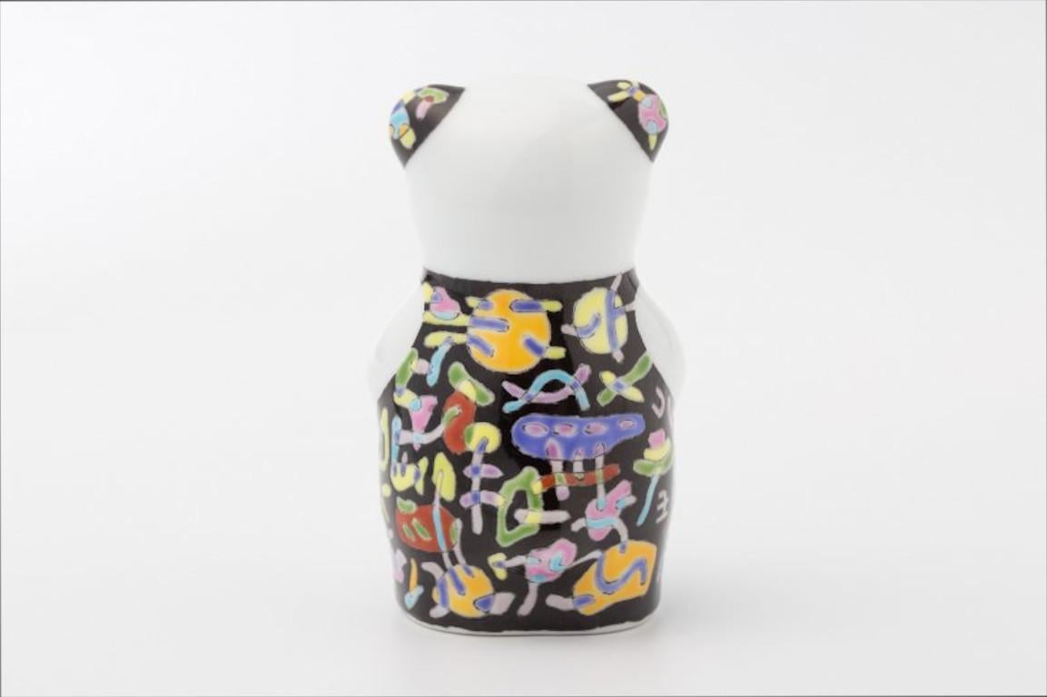 Extraordinary Japanese contemporary porcelain bear sculpture, hand-painted in black, blue, yellow and green in a dramatic auspicious traditional Japanese pattern set against a black background, by Japanese artist from the historic Imari-Arita region