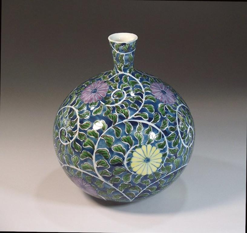 Japanese contemporary decorative porcelain vase, intricately hand painted in green on a beautiful bottle shape body, a signed work by highly acclaimed master porcelain artist of the Imari-Arita region of Japan and the recipient of numerous awards