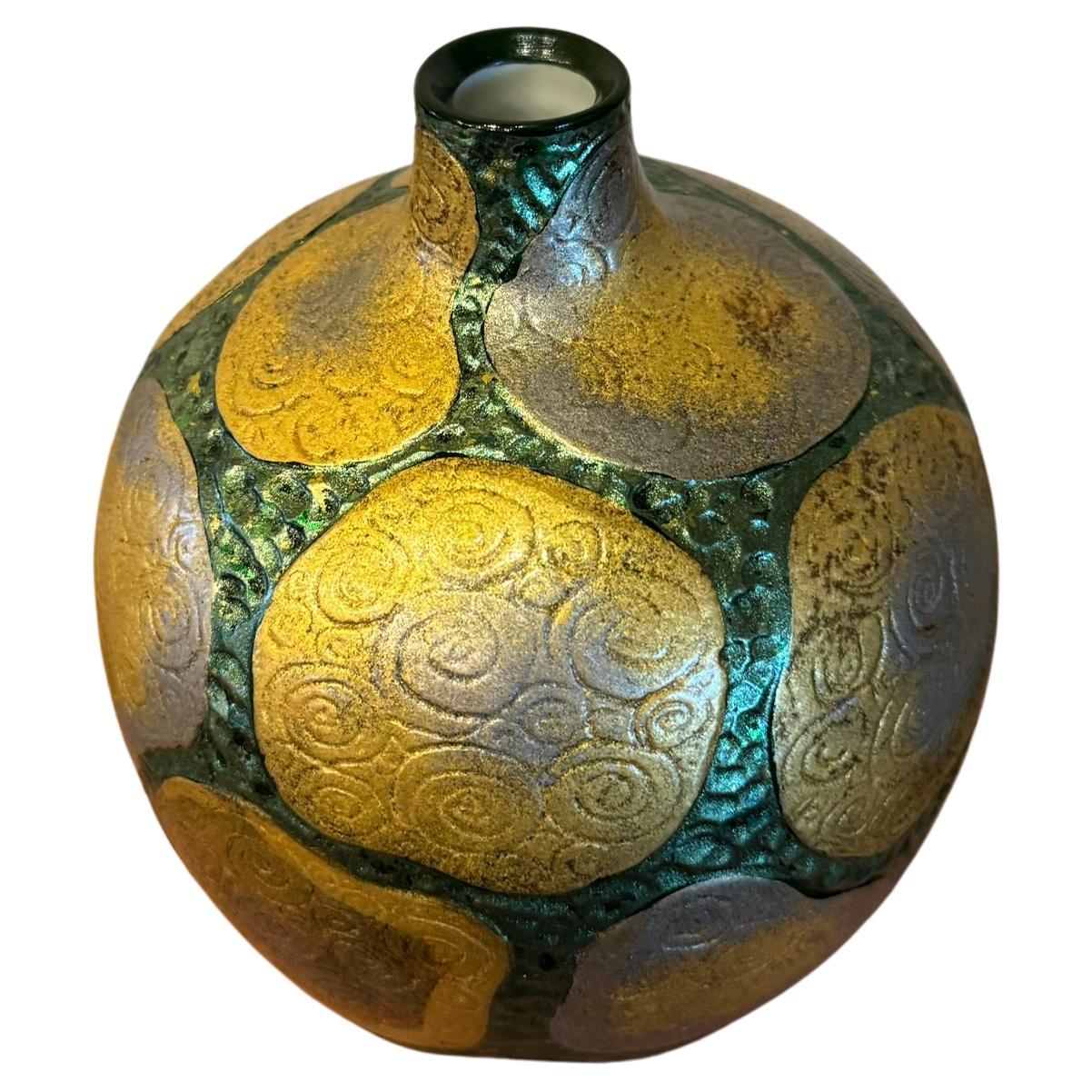 Extraordinary decorative porcelain vase with mysterious intricate etchings features platinum, gold foils plus silver foil tinted in shades of vivid green, meticulously positioned using lacquer as an adhesive and sealed to the vase in a