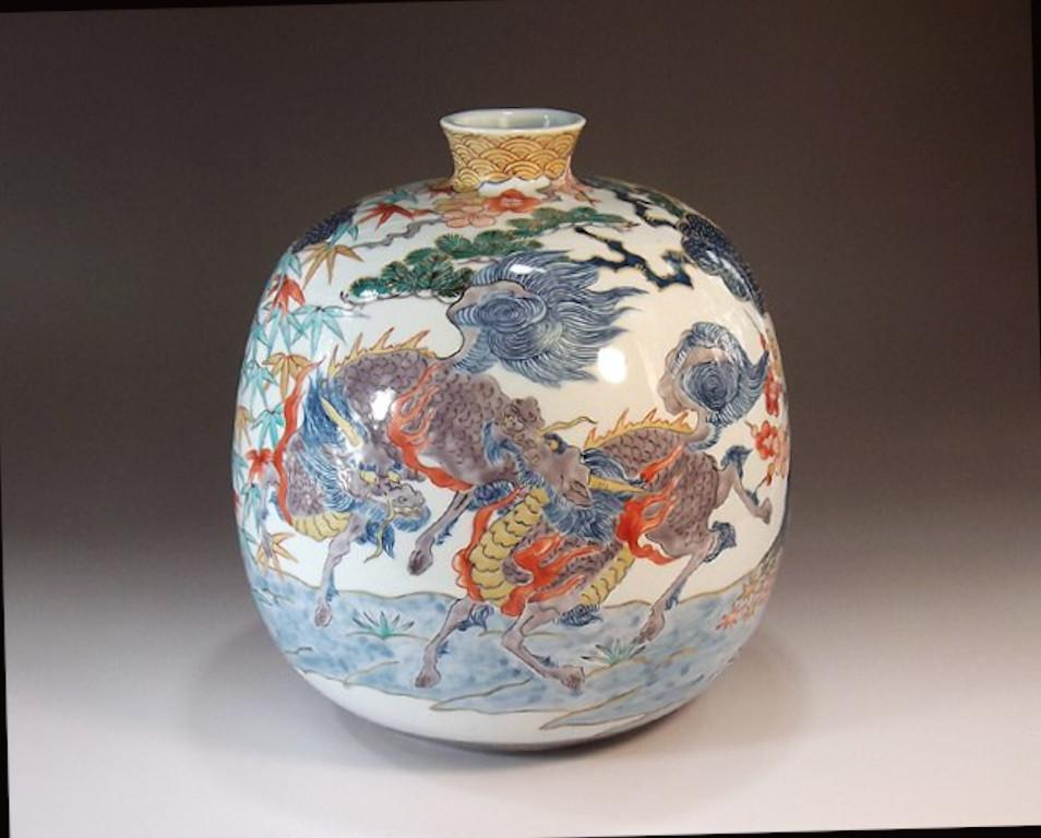 Contemporary Japanese decorative porcelain vase, hand painted in green, blue, red and gold on a stunningly shaped porcelain body, a signed work by highly acclaimed award-winning master porcelain artist of the Imari-Arita region of Japan. In 2016,
