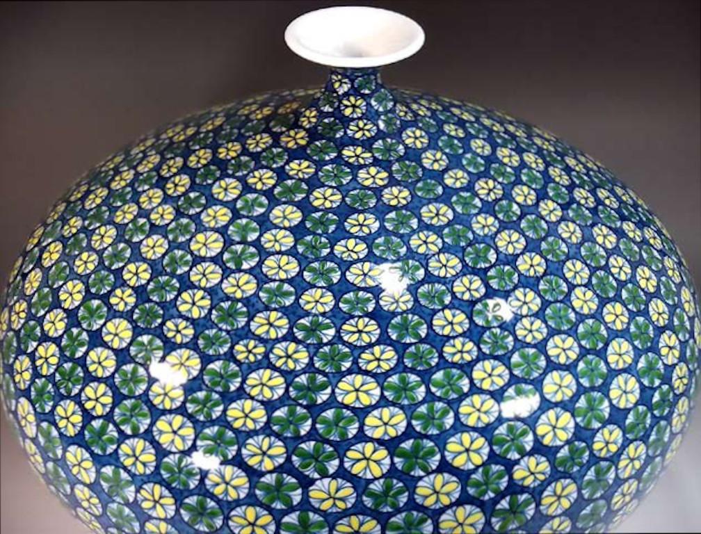Exceptional Japanese contemporary decorative porcelain vase, intricately hand-painted in blue, green, yellow and black, from the artist's stunning geometric collection, a masterpiece by master artist of the Imari- Arita region of Japan featuring a