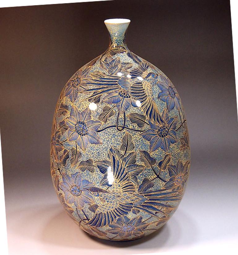 Unique exquisite contemporary Japanese decorative porcelain vase, hand painted on a beautifully shaped porcelain body in blue, with extremely intricate patterns and extensive use of gold, creating a beautiful palette with layers of transparent