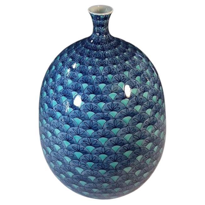 Japanese contemporary decorative porcelain vase, hand-painted in blue, green and black, from the artist's stunning geometric pattern collection, created by this artist of the Imari- Arita region of Japan featuring a blue geometric design set against