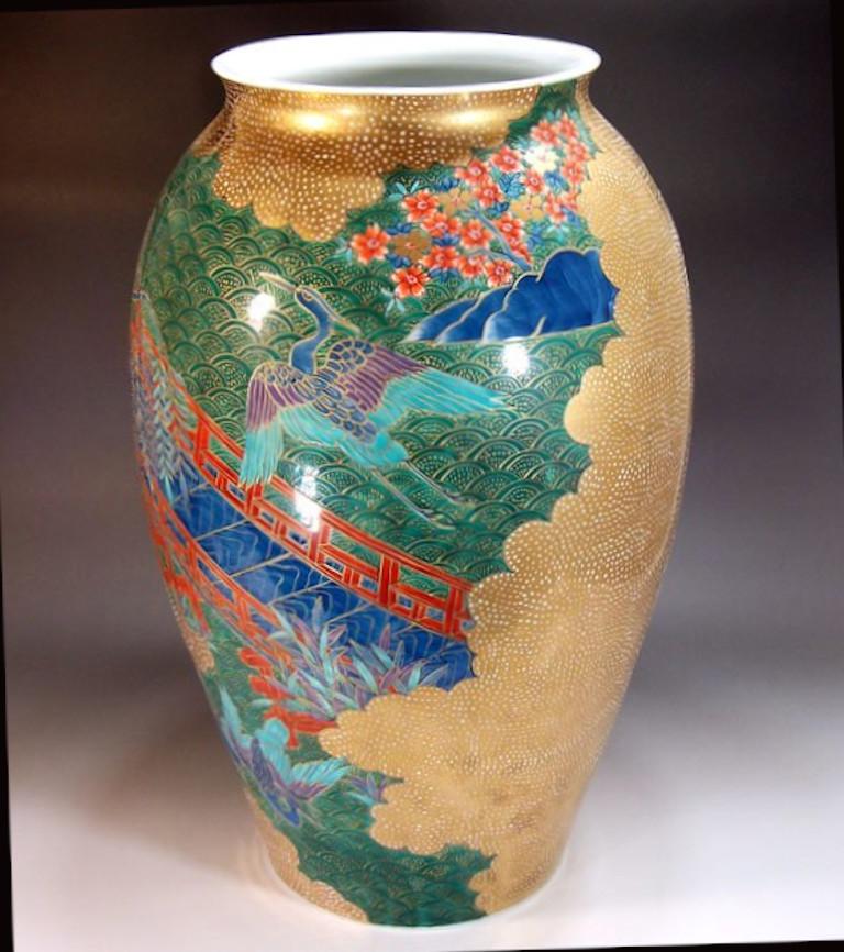 Mesmerizing very large contemporary Japanese decorative porcelain vase, intricately hand-painted in blue, green and red on a beautifully shaped body and gilded, featuring a stunning combination of polychrome overglaze and extensive gilding. It is a