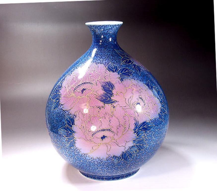 Exquisite contemporary Japanese Imari decorative porcelain vase, extremely intricately gilded and hand-painted on a stunningly shaped ovoid fine porcelain in different shades of blue and pink to create a mesmerizing transparent surface. It is