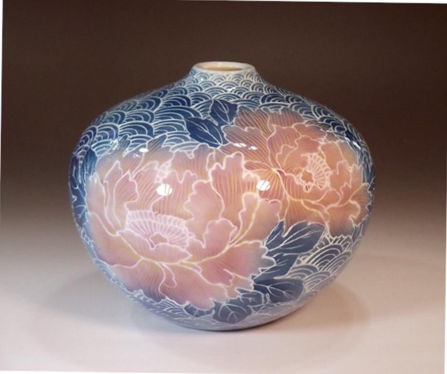 Exceptional Japanese contemporary decorative porcelain vase, extremely intricately gilded and hand painted on a beautifully shaped ovoid porcelain body in various shades of blue and pink to create a mesmerizing transparent surface. It is lavishly