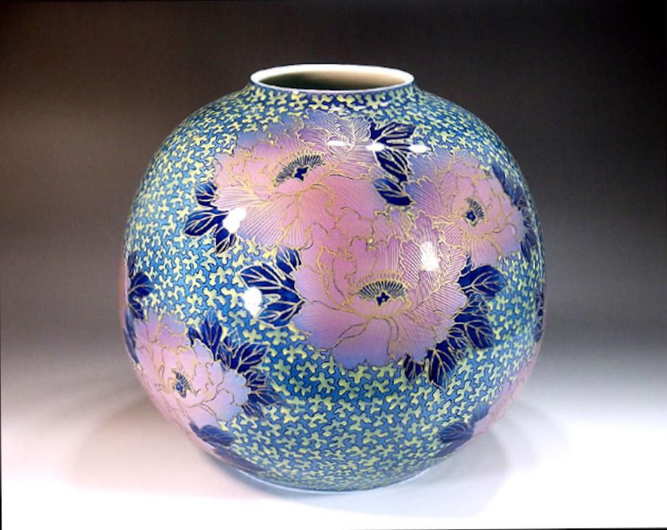 Exquisite large contemporary Japanese decorative porcelain vase, intricately hand painted on an elegantly shaped porcelain body in beautiful shades of blue and pink to create a transparent surface. It is lavishly decorated with generous intricate