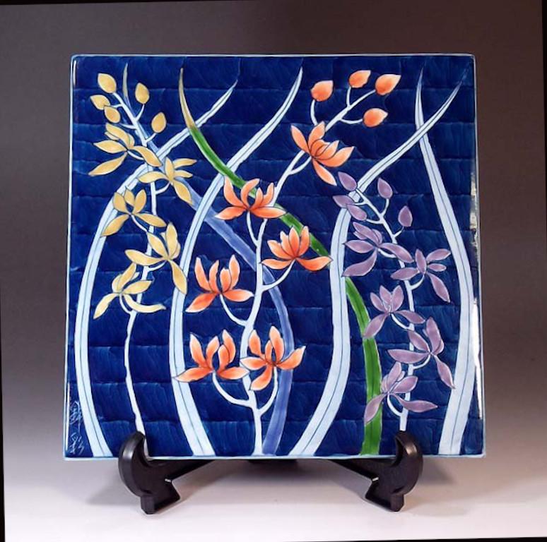 Exuisite Japanese contemporary decorative square porcelain charger, hand painted in vivid pink, blue, green and platinum, and signed by a widely acclaimed master porcelain artist of Japan’s Imari-Arita region. The artist is the recipient of numerous