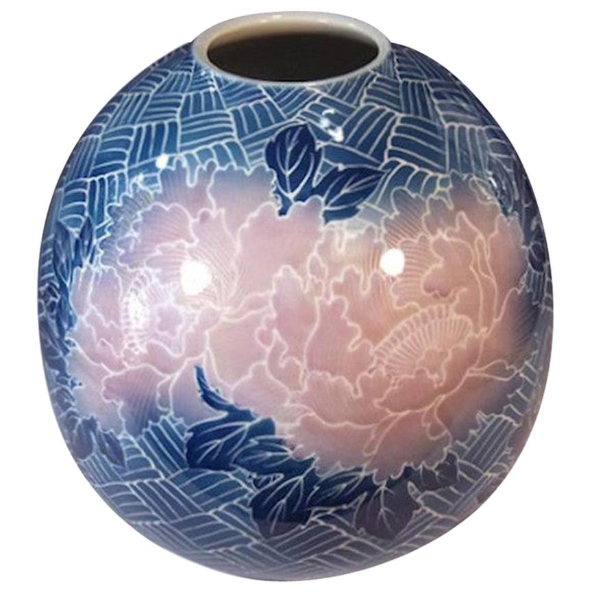 Exquisite Japanese contemporary porcelain vase, hand painted in deep blue and pink, a signed work by master artist of the Imari- Arita region of Japan featuring giant soft salmon pink peonies set against a white background adorned with a stunning