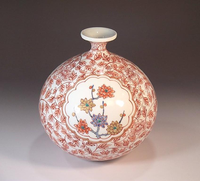 Japanese contemporary decorative porcelain vase, intricately hand painted in red, pink, green and blue on beautifully shaped ovoid porcelain body in a stunning floral background. Three scalloped panels with bamboo, pine and floral motifs decorate