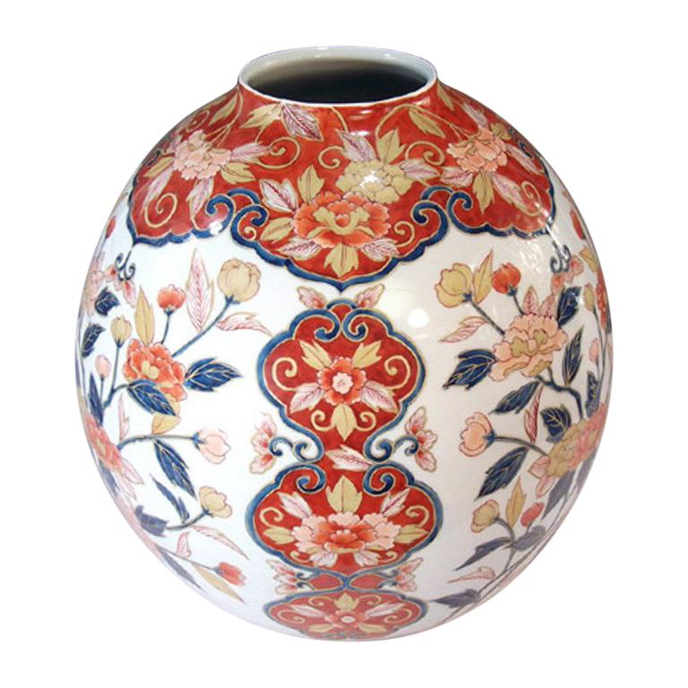 Extraordinary large Japanese contemporary decorative porcelain vase, strikingly hand-painted in vivid blue, red, pink and cream with generous gold details, on a stunningly shaped body in pure white. It is a signed masterpiece by highly acclaimed
