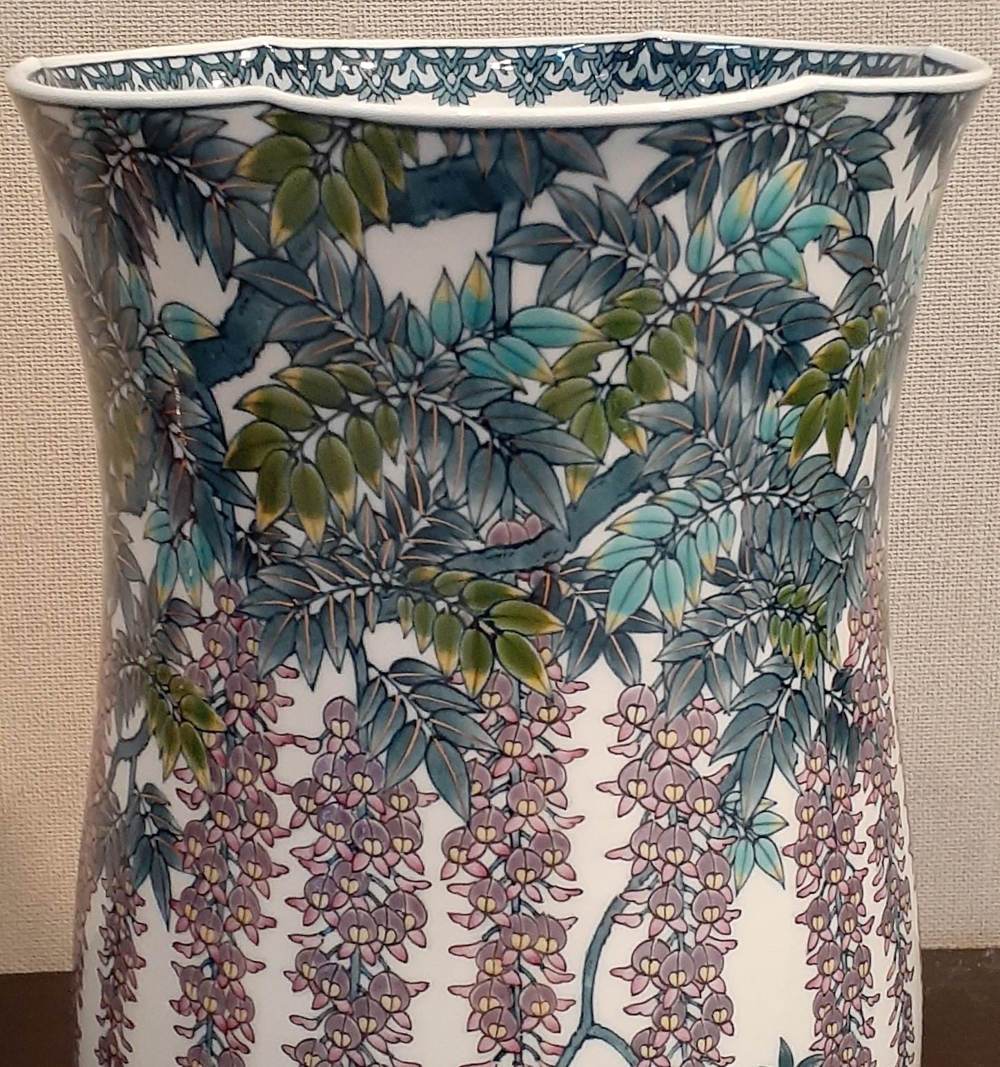 Exquisite contemporary Japanese museum-quality decorative signed porcelain vase, extremely intricately hand painted in vivid purple, blue and turquoise to showcase dramatic wisterias and vines, on an elegantly shaped body with a stunning scaloped