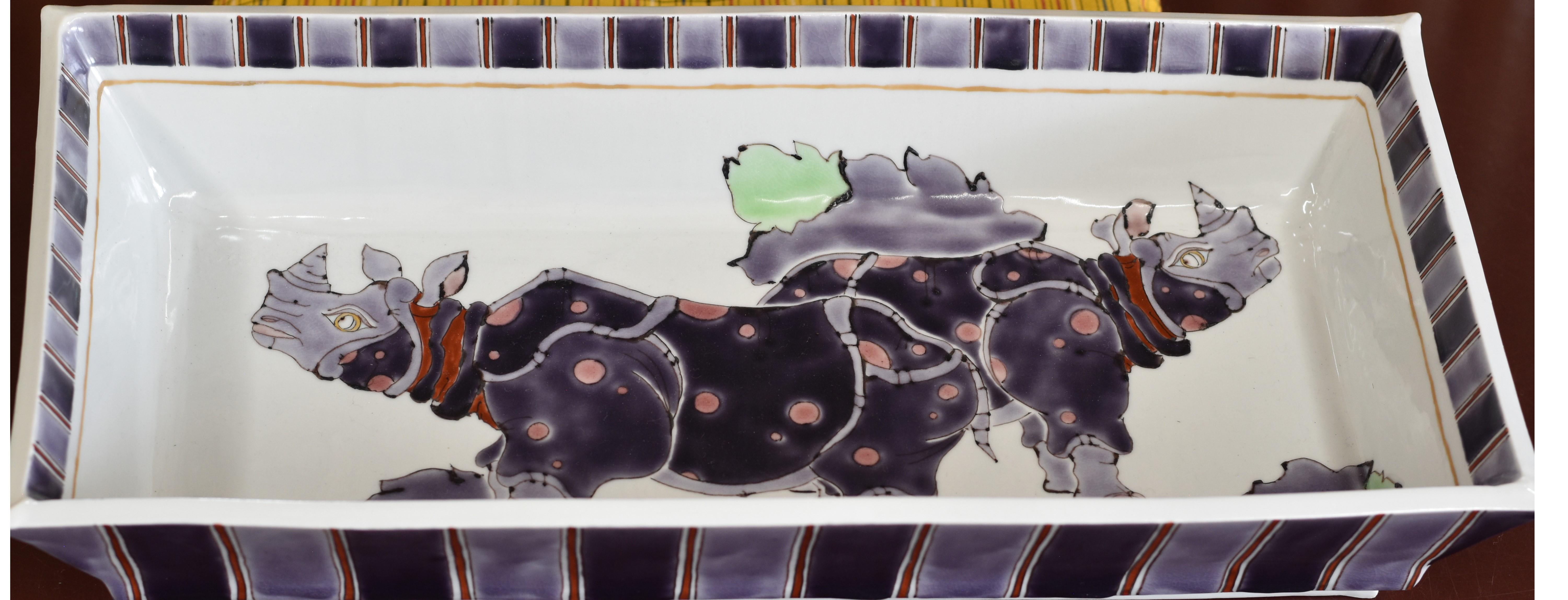 Extraordinary museum quality Japanese contemporary signed decorative porcelain deep charger, dramatically hand painted on an elegant rectangular body in vivid hues of purple, red and gray, with a unique interpretation of rhinoceros. This highly