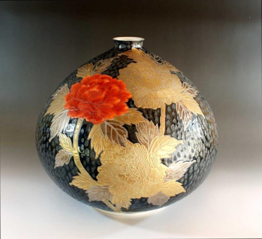 Striking Japanese  contemporary decorative porcelain vase, hand painted in vivid red, platinum and gold on a beautifully shaped dimpled porcelain body in black, a exquisite signed piece by widely respected master porcelain artist in Imari-Arita