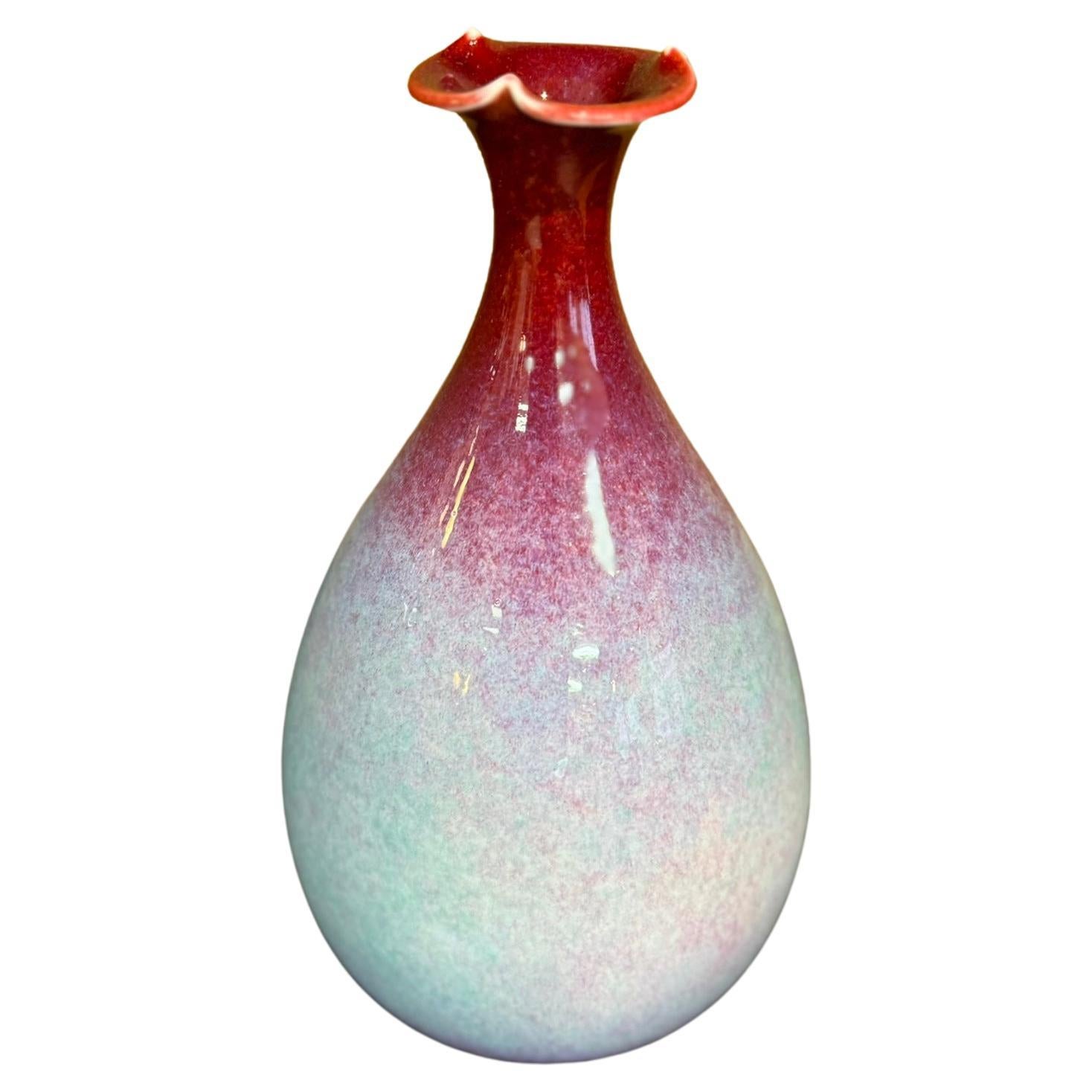 Squisito vaso decorativo giapponese contemporaneo in porcellana, smaltato a mano con il caratteristico rosso vivo dell'artista nella parte superiore e con uno straordinario colore crema bluastro-verdognolo nella parte inferiore di questo pezzo dalla
