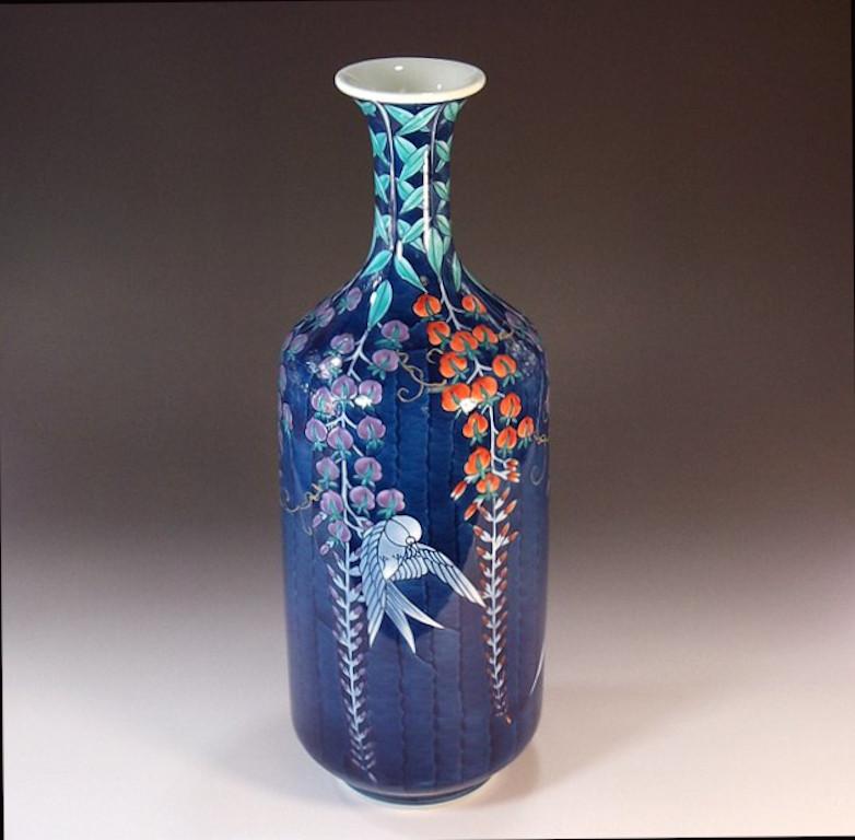 Japanese contemporary decorative porcelain vase, intricately hand painted in blue, purple and red on a beautifully shaped porcelain body, a signed piece by highly acclaimed master porcelain artist of Japan’s Imari-Arita region. The artist is the