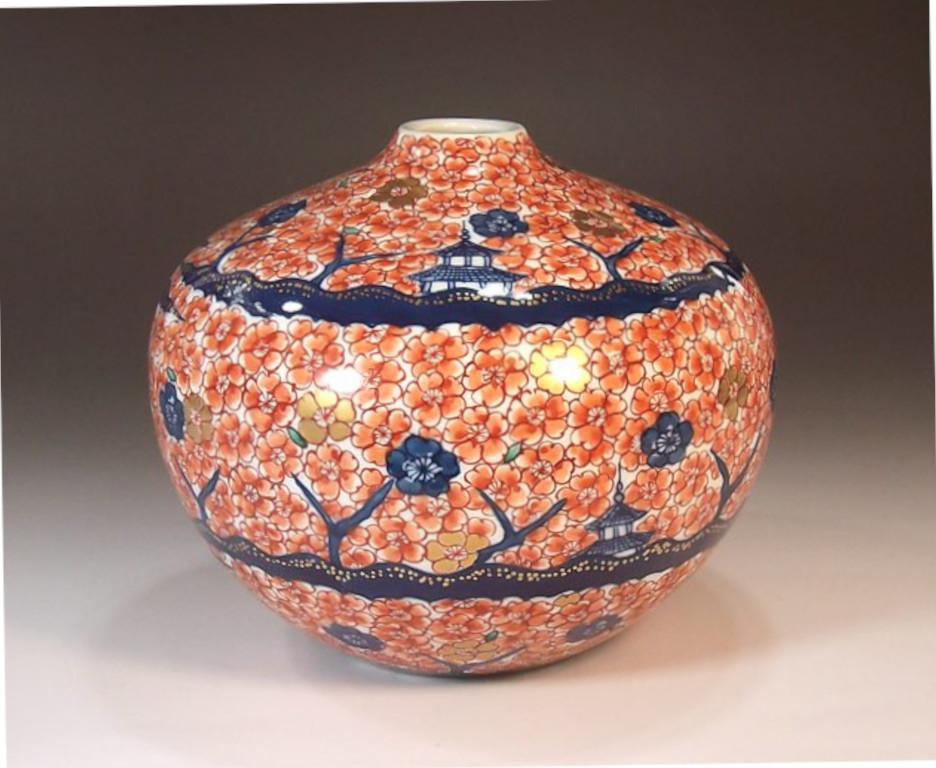 Contemporary Japanese decorative porcelain vase, intricately hand painted in red and blue on a stunningly shaped porcelain body, by widely acclaimed master porcelain artist in traditional patterns of the Imari-Arita region of Japan and the recipient