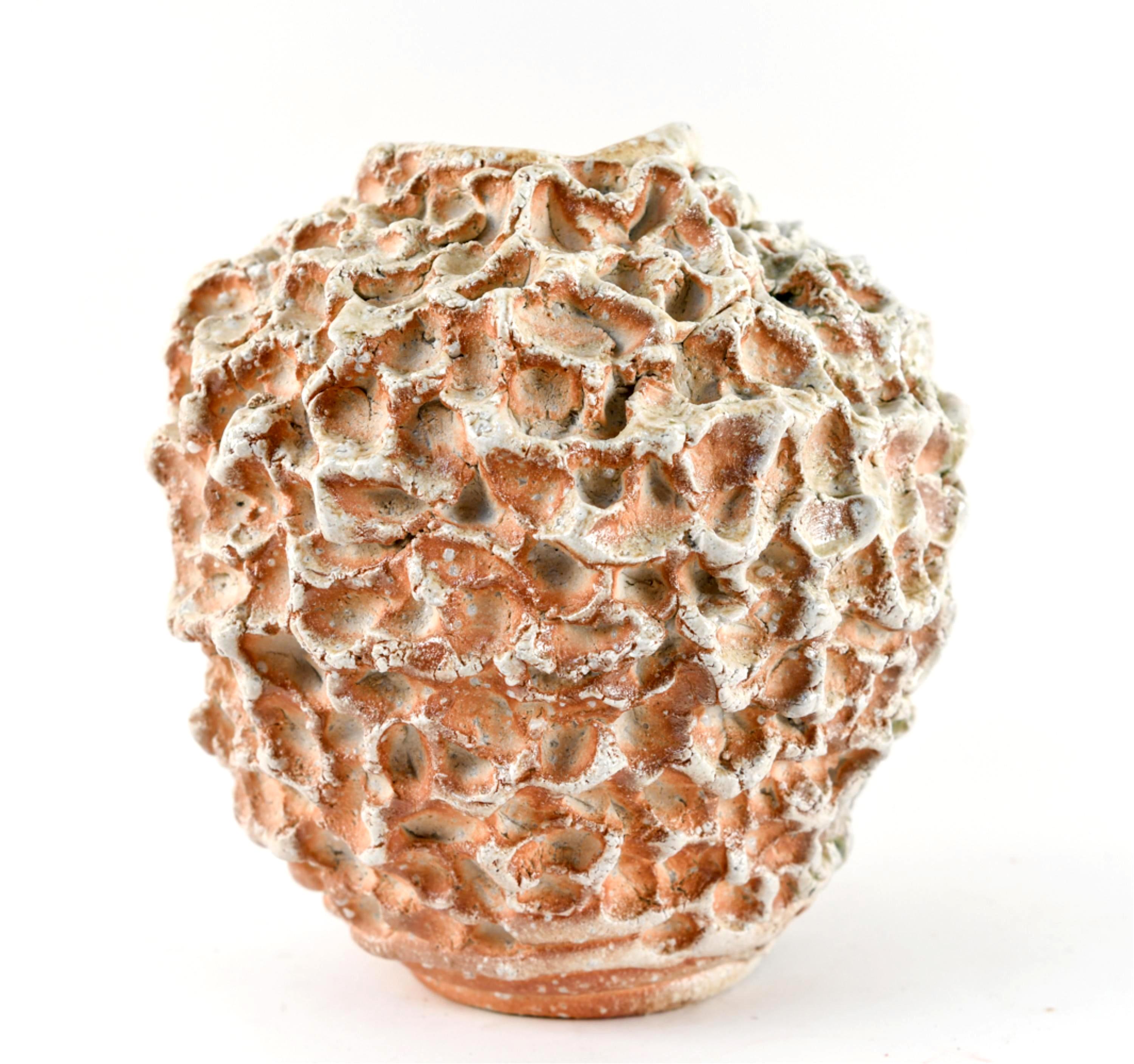 A stoneware vessel in globular form in the tradition of wood fire Shigaraki ware, with pinched ridges and indentations and natural ash and partial celadon glaze, made by Japanese contemporary ceramist Satoru Hoshino (1945-) signed, sealed and dated