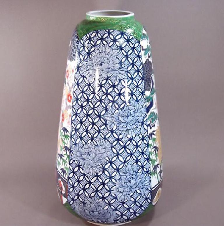 Magnificent tall Japanese contemporary decorative porcelain vase, hand painted in blue, red, green and pink on a beautifully shaped body in pure white, a signed masterpiece by widely acclaimed master porcelain artist from the Imari-Arita region of