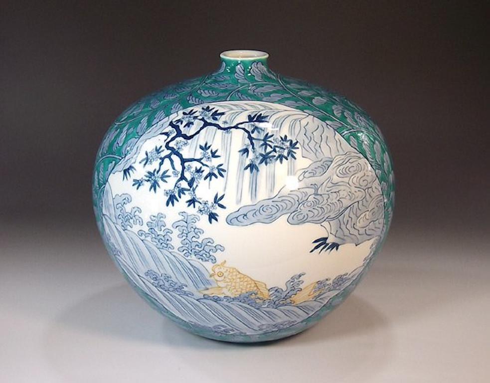Unique contemporary Japanese porcelain decorative vase, extremely intricately hand painted in an auspicious karakusa pattern in underglaze blue and white with some green , depicting scenes from Japan's countryside showcased on two cartouches , a