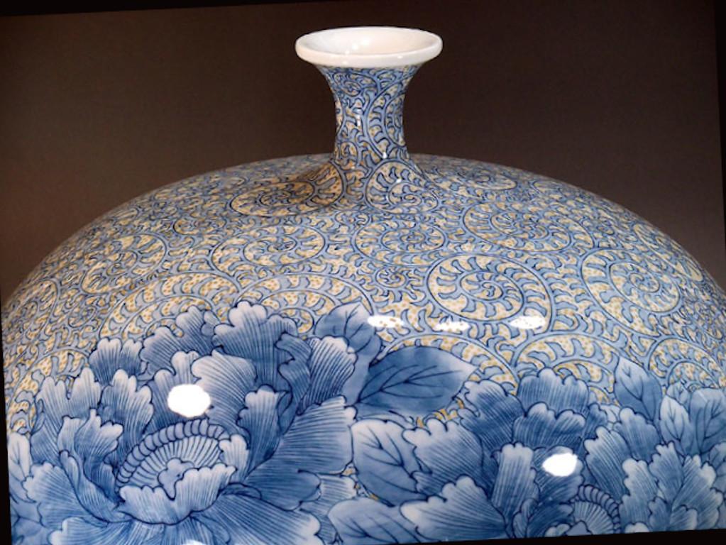 Exquisite contemporary Japanese decorative porcelain vase, intricately hand painted in blue underglaze and yellow on a stunningly shaped porcelain body, by widely acclaimed master porcelain artist in traditional patterns of the Imari-Arita region of