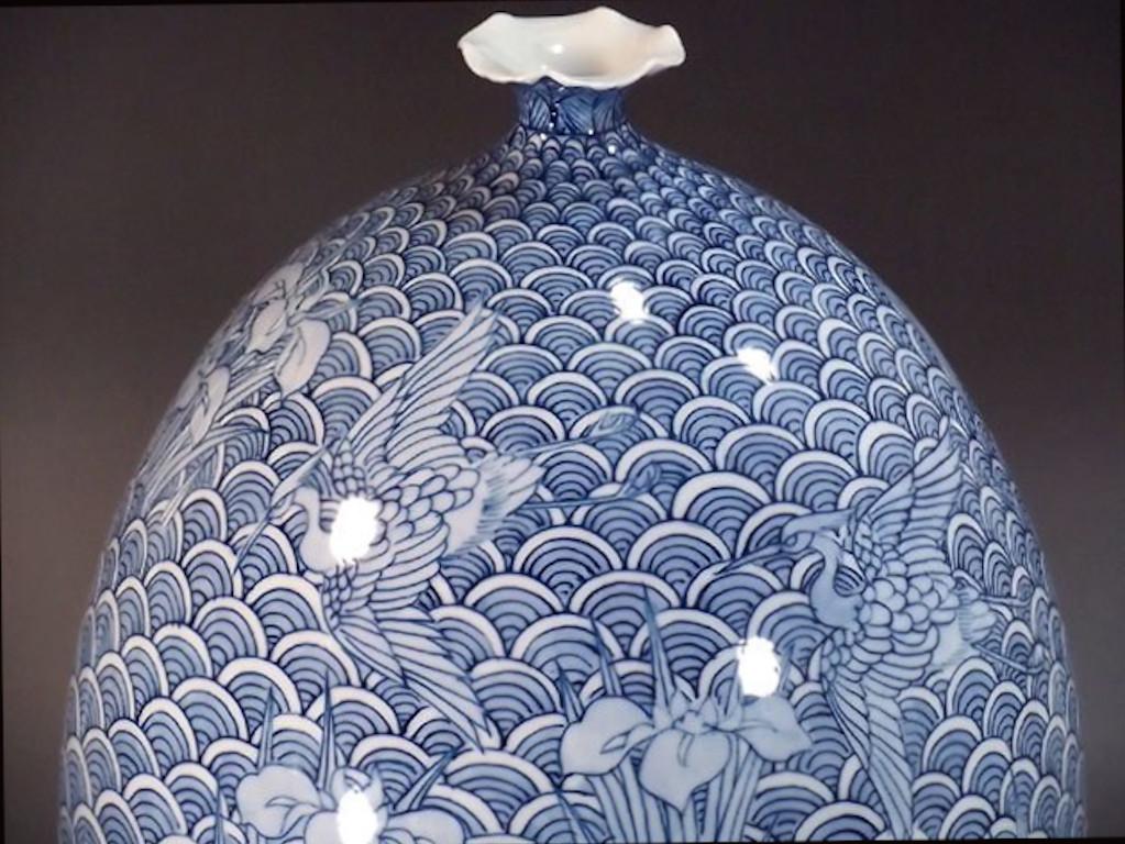 Elegant Japanese contemporary decorative porcelain vase, signed masterpiece intricately hand-painted in blue underglaze on a beautifully shaped porcelain body, a work by highly acclaimed master porcelain artist and recipient of numerous awards. In