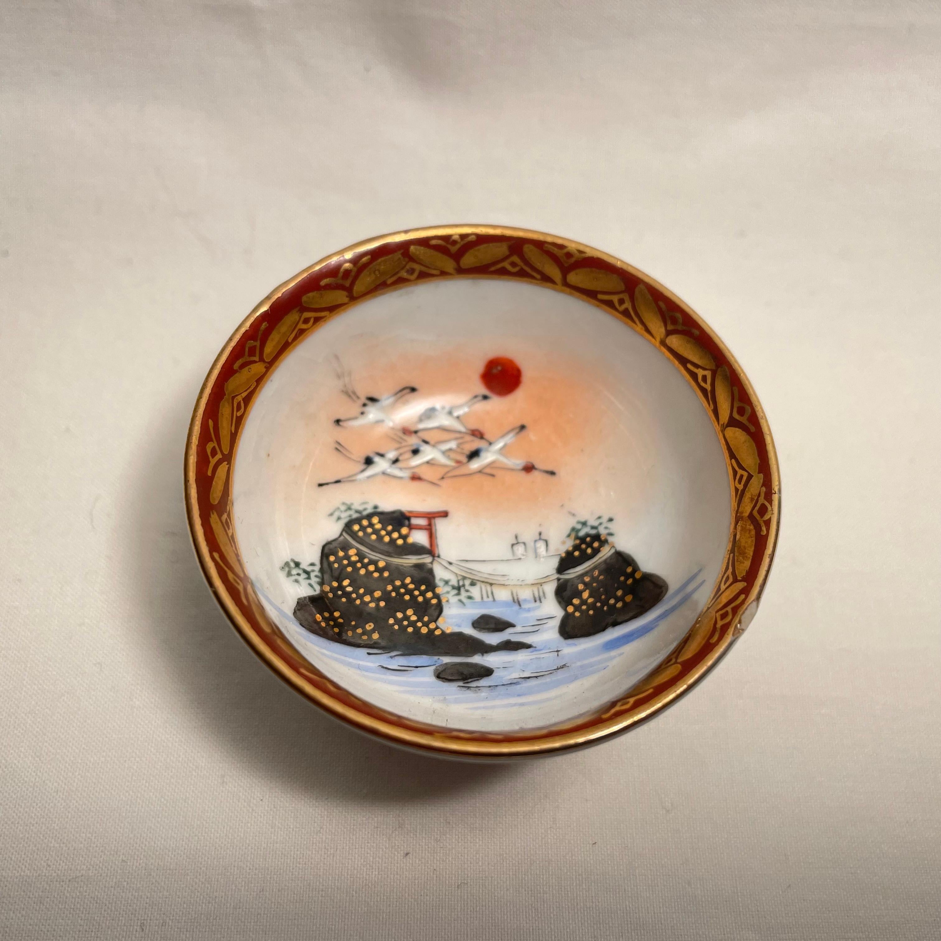 This is a small cup for drinking sake. It is called Ochoko in Japanese.
It was made in showa era around 1960s.  It is made with porcelain and all hand painted. 
This is Kutani ware.
Design is with a paysage of ISE.

Dimensions:
5,2 x 5,2 x H2,5 cm