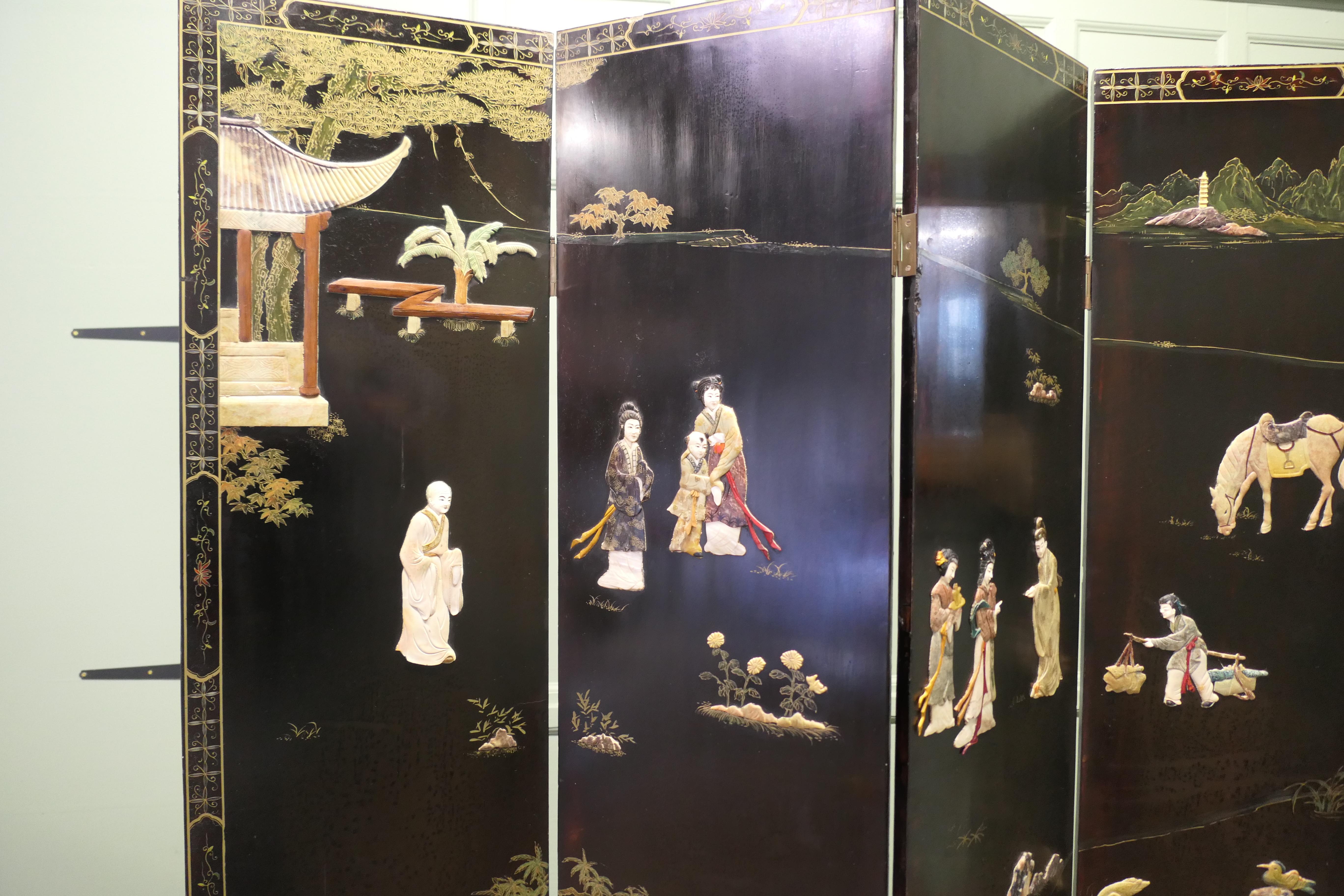 Japanese Decorated Lacquer and Painted Folding Screen 

This impressive screen has four superbly decorated panels with a montage of Geisha, Japanese Garden and Animals all made from carved minerals in a continuous picture.
The other side of the